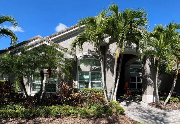 Florida home with new impact windows and palms